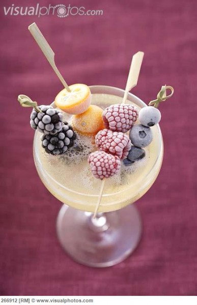 frozen fruit skewers in a saucer of champagne 266912